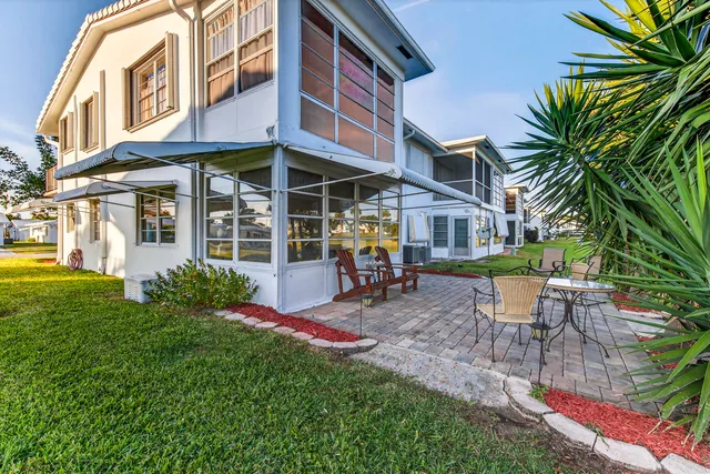 a kitchen with stainless steel appliances a refrigerator a sink and white cabinets