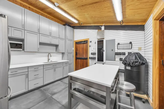 a view of an entrance to house with yard and potted plants