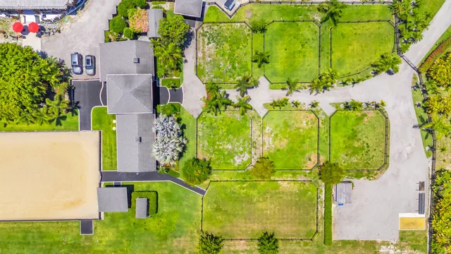 an aerial view of a tennis ground and a houses