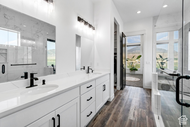1952 Highway 118 Monroe, UT 84754 - Photo 31 of 88 Bathroom with plenty of natural light, double vanity, recessed lighting, a marble finish shower, and wood finished floors