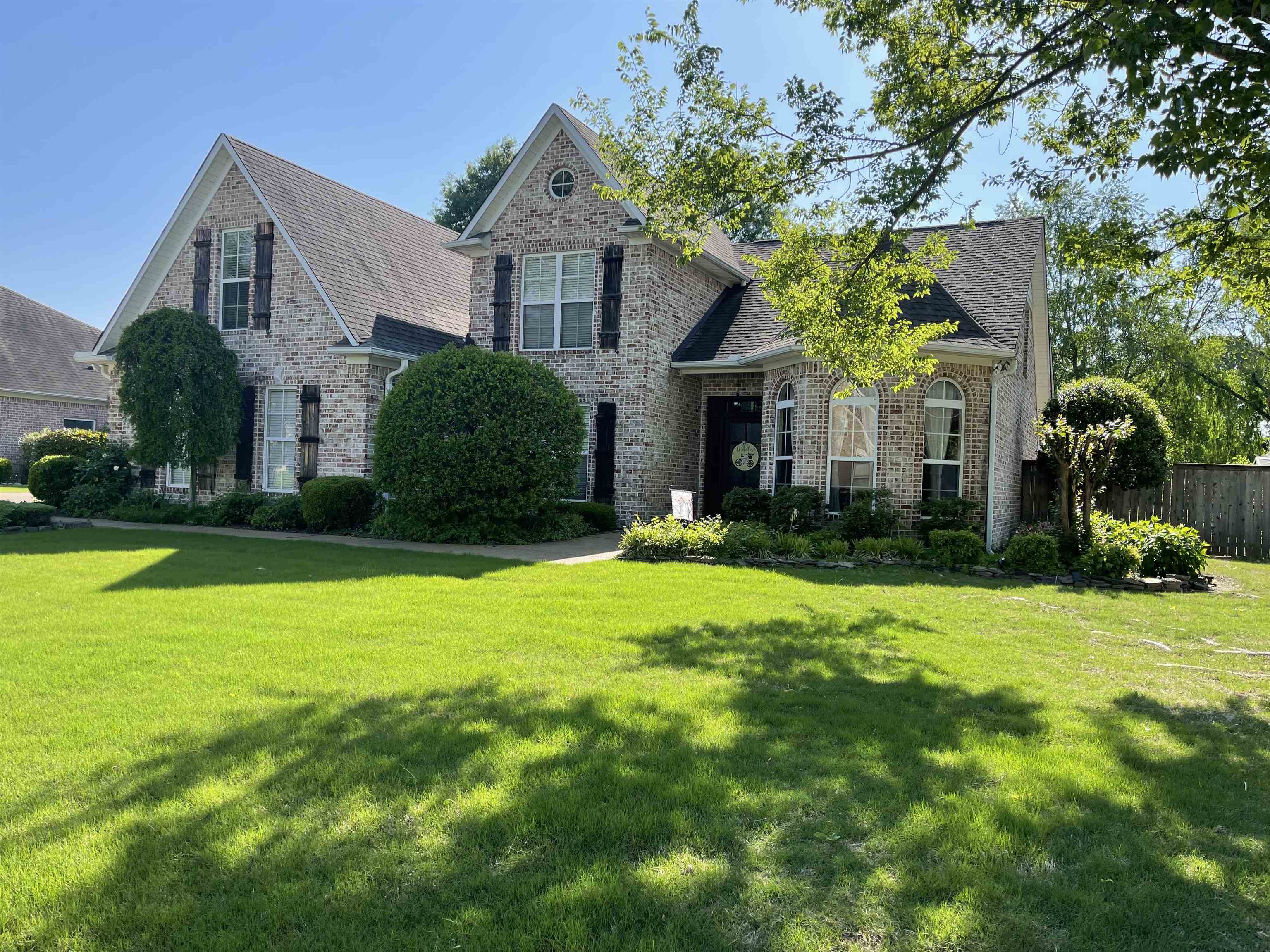 a front view of a house with a yard