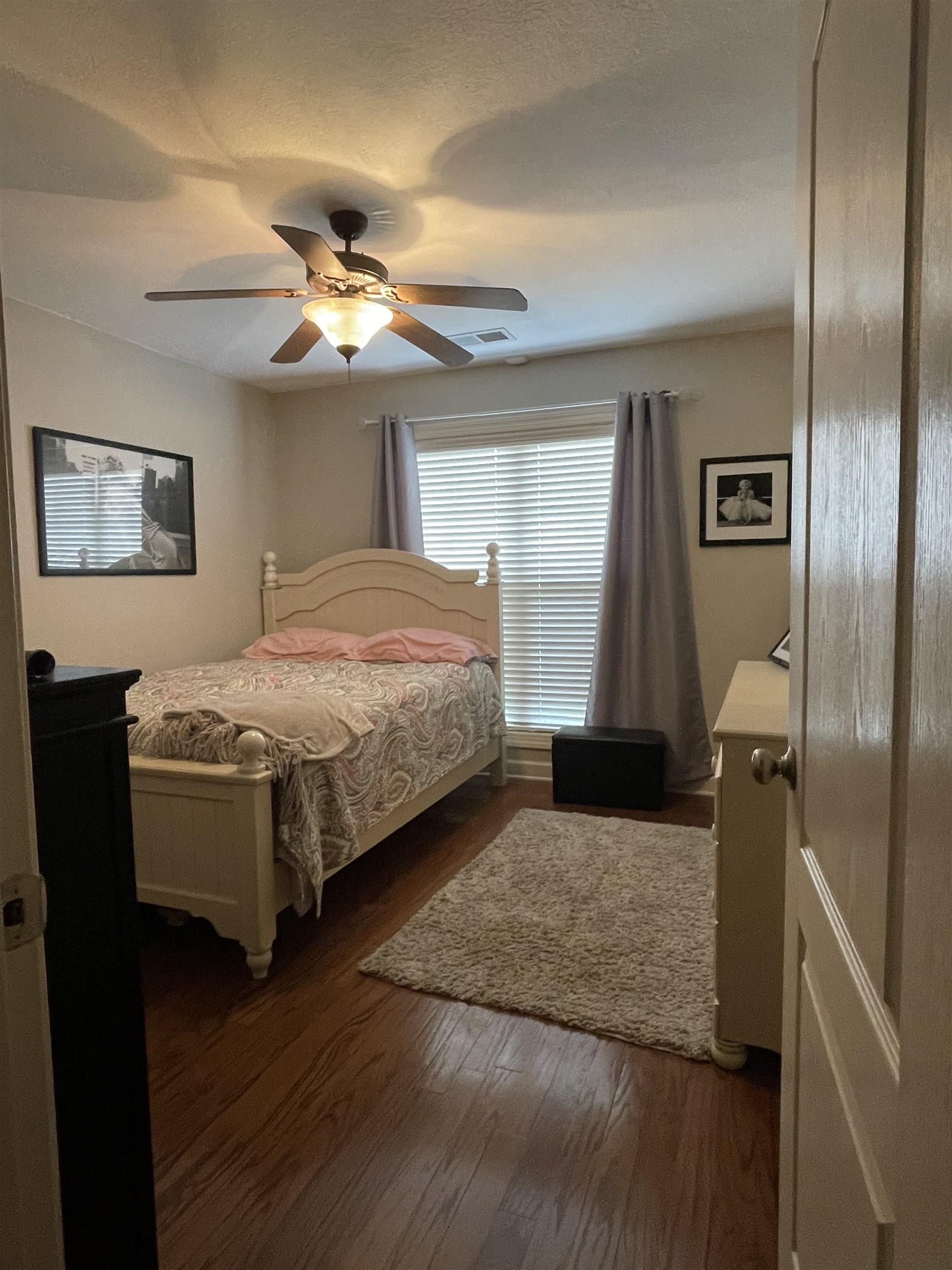 17 Flagstone Drive Jackson, TN 38305 - Photo 12 of 16 a bedroom with a bed and a chandelier