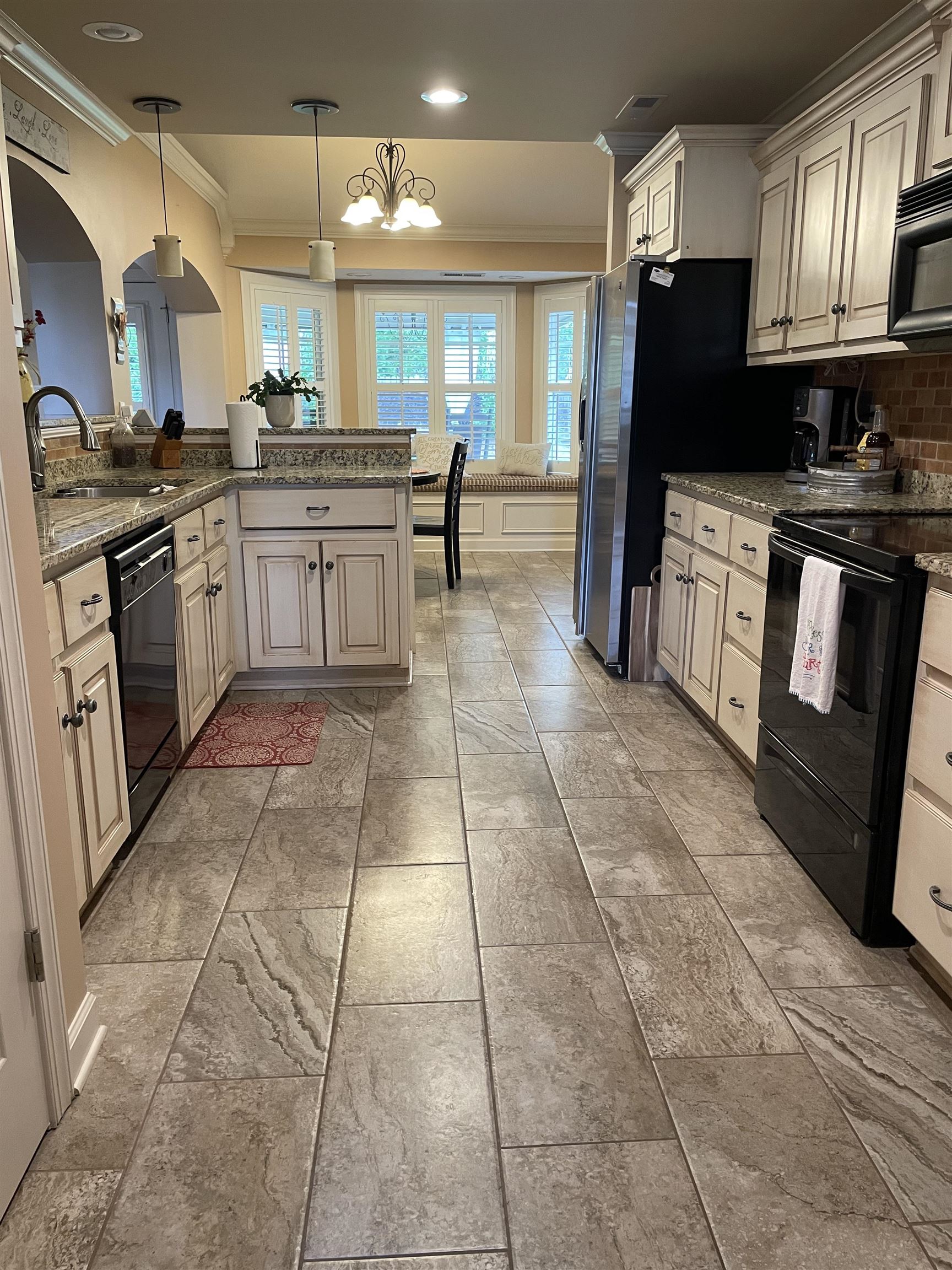 17 Flagstone Drive Jackson, TN 38305 - Photo 7 of 16 a kitchen with stainless steel appliances granite countertop a stove a sink dishwasher and a refrigerator