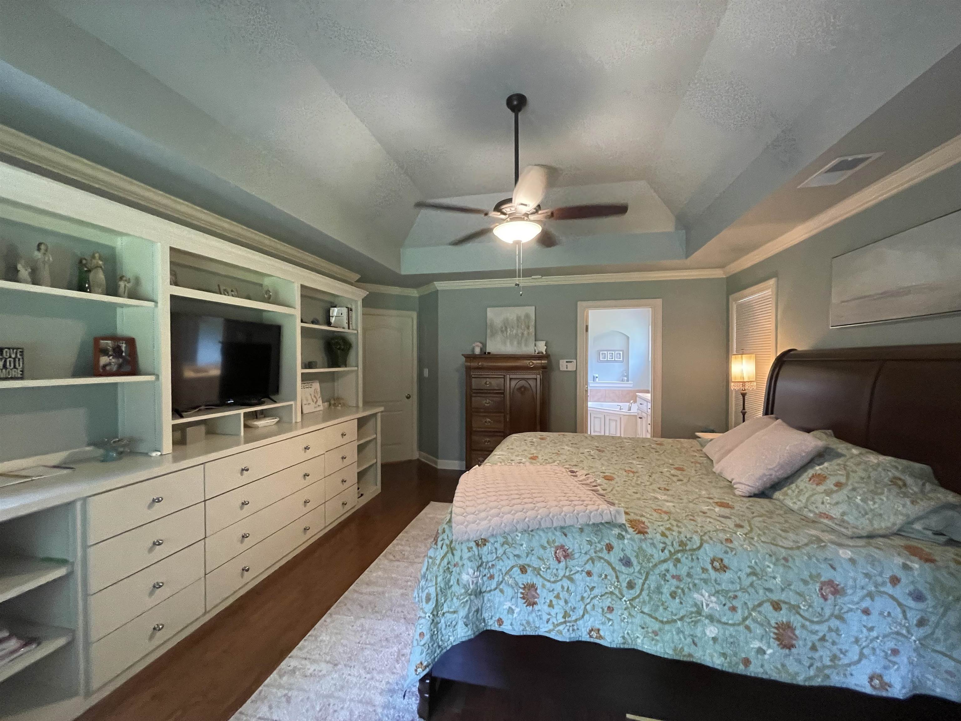 17 Flagstone Drive Jackson, TN 38305 - Photo 9 of 16 a bedroom with a large bed and a flat tv screen on dresser