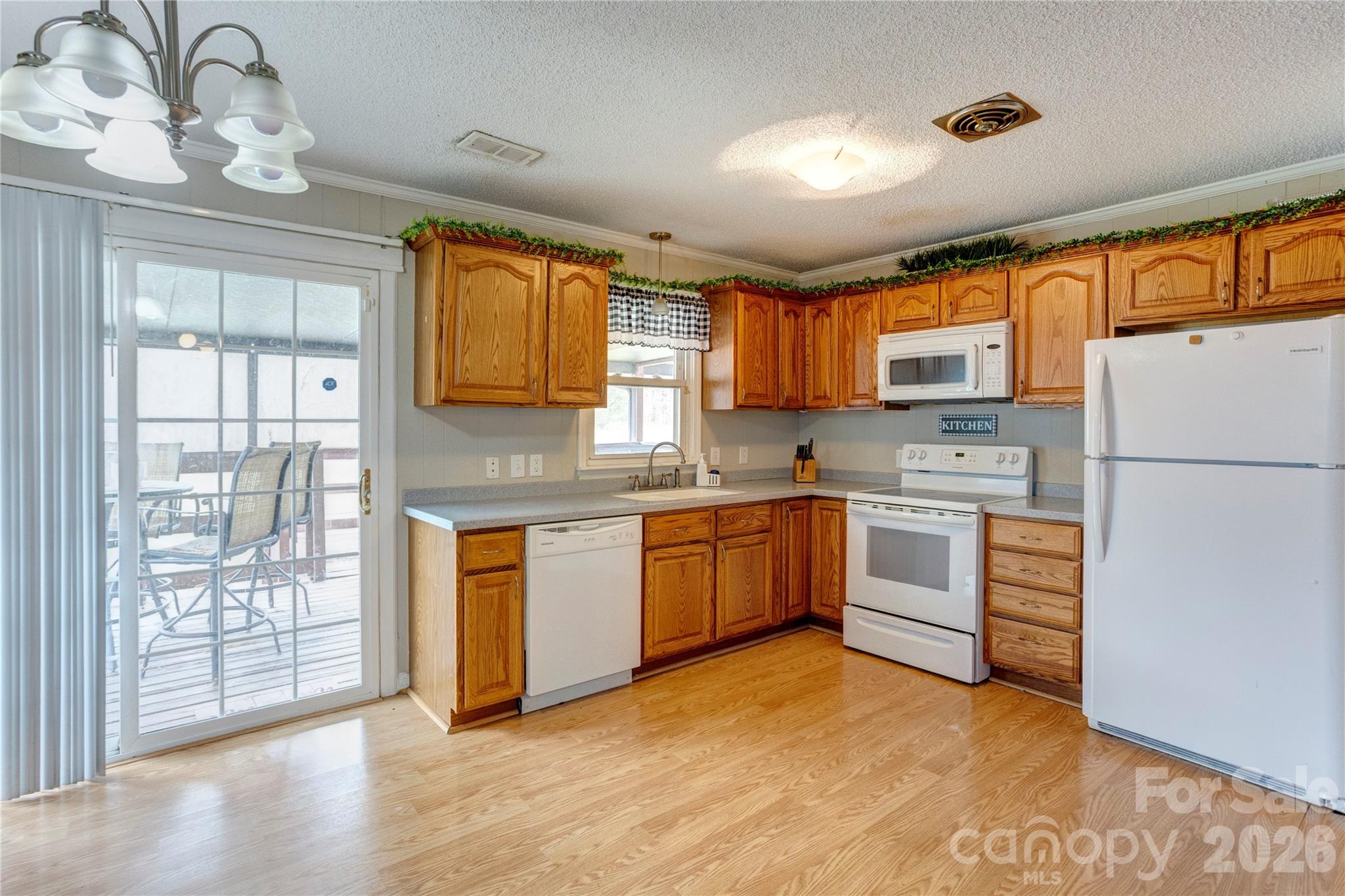 455 Rimer Road Salisbury, NC 28146 - Photo 4 of 22 a kitchen with granite countertop white cabinets and white appliances