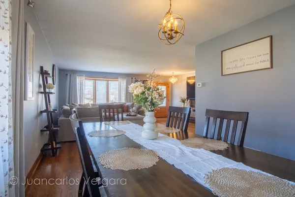 a view of a dining room with furniture window and wooden floor