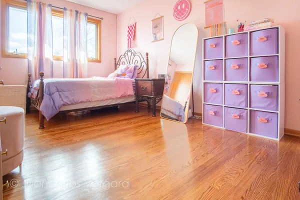 a spacious bedroom with a bed and a window