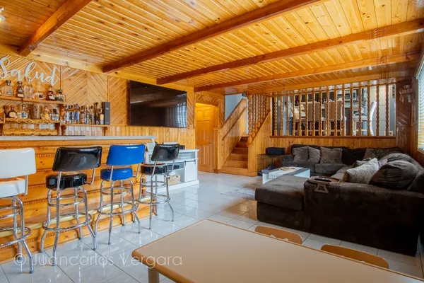 a living room with furniture and a floor to ceiling window