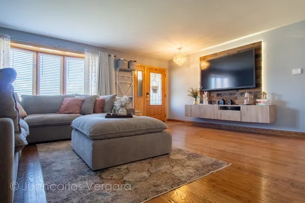 a living room with furniture and a wooden floor
