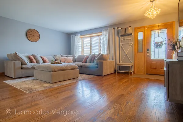 a view of a livingroom with furniture wooden floor and window