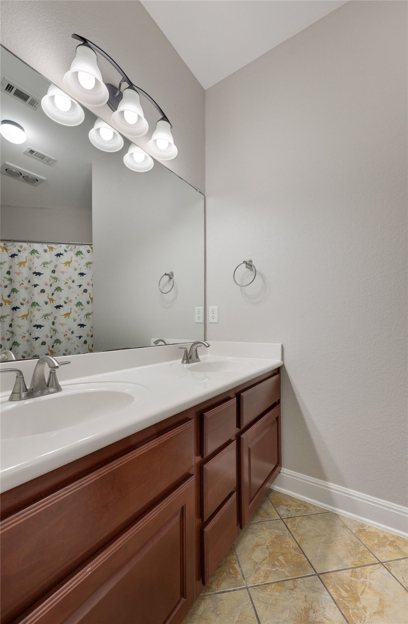 433 Ridgetop Bend Cedar Park, TX 78613 - Photo 33 of 34 Full bath featuring double vanity, curtained shower, and light tile patterned flooring