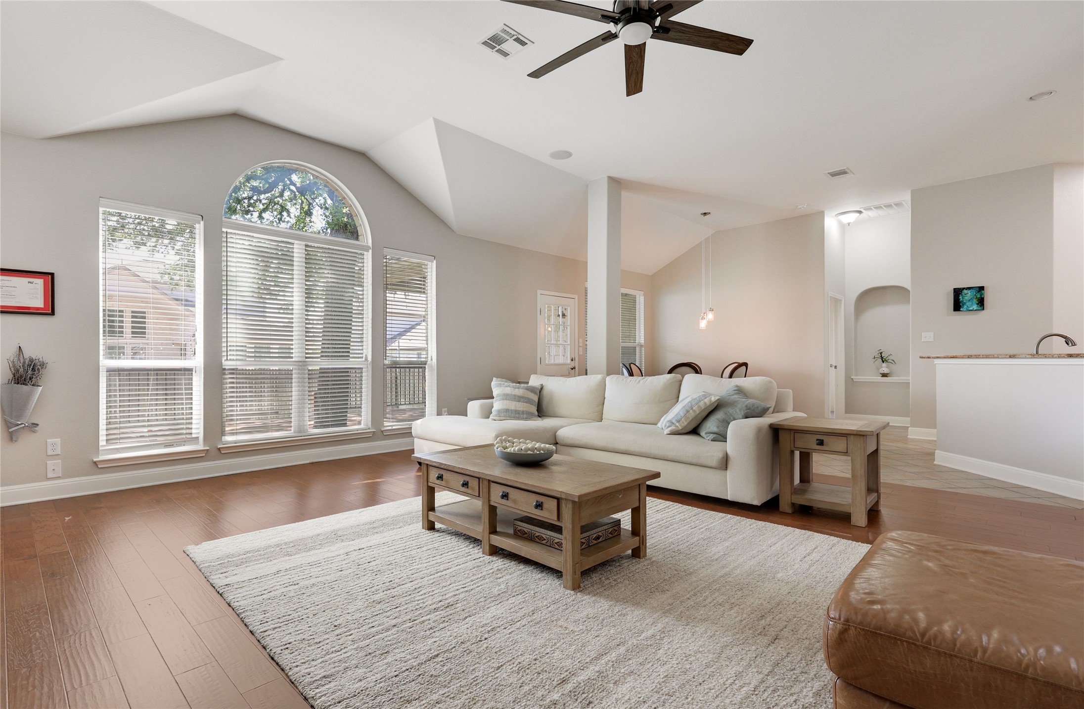 433 Ridgetop Bend Cedar Park, TX 78613 - Photo 4 of 34 Living area with vaulted ceiling, a ceiling fan, wood finished floors, and arched walkways
