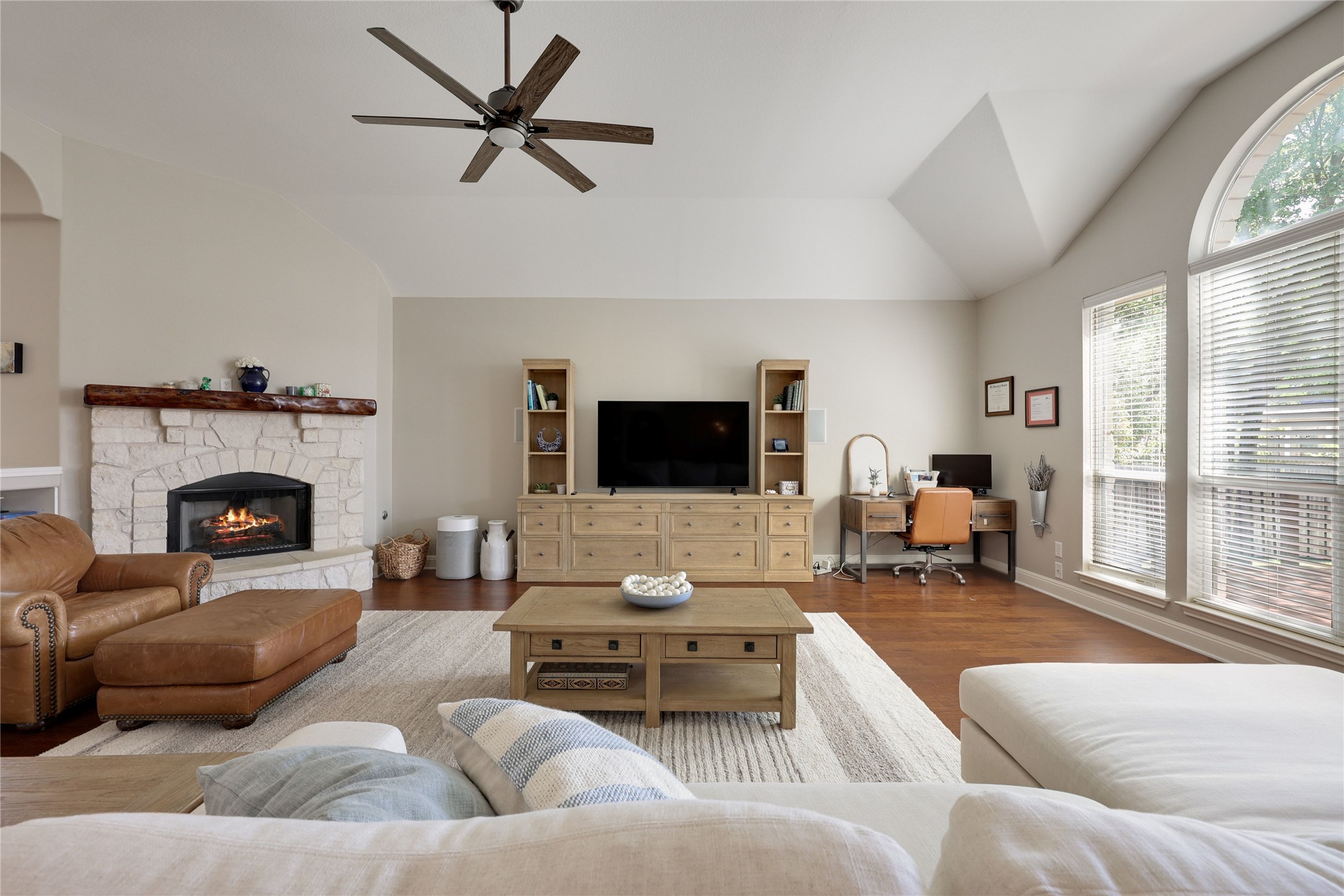 433 Ridgetop Bend Cedar Park, TX 78613 - Photo 5 of 34 Living room featuring a ceiling fan, wood finished floors, a fireplace, lofted ceiling, and an office area