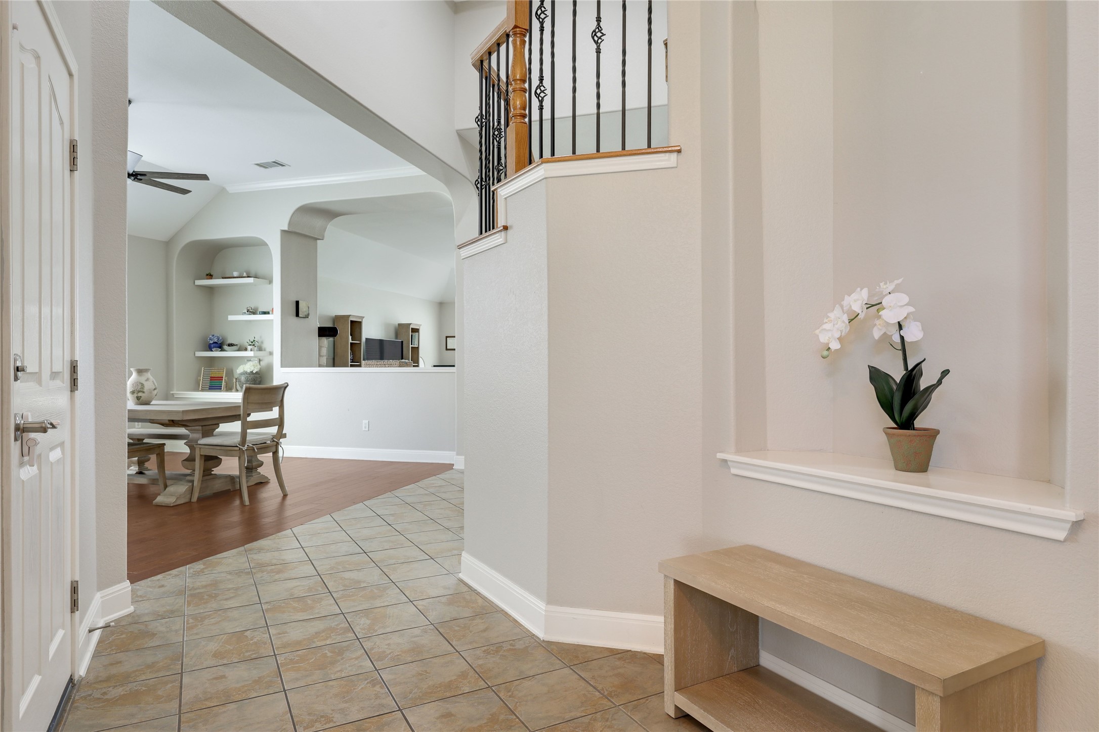 433 Ridgetop Bend Cedar Park, TX 78613 - Photo 8 of 34 Hallway featuring built in features, light tile patterned floors, arched walkways, and vaulted ceiling