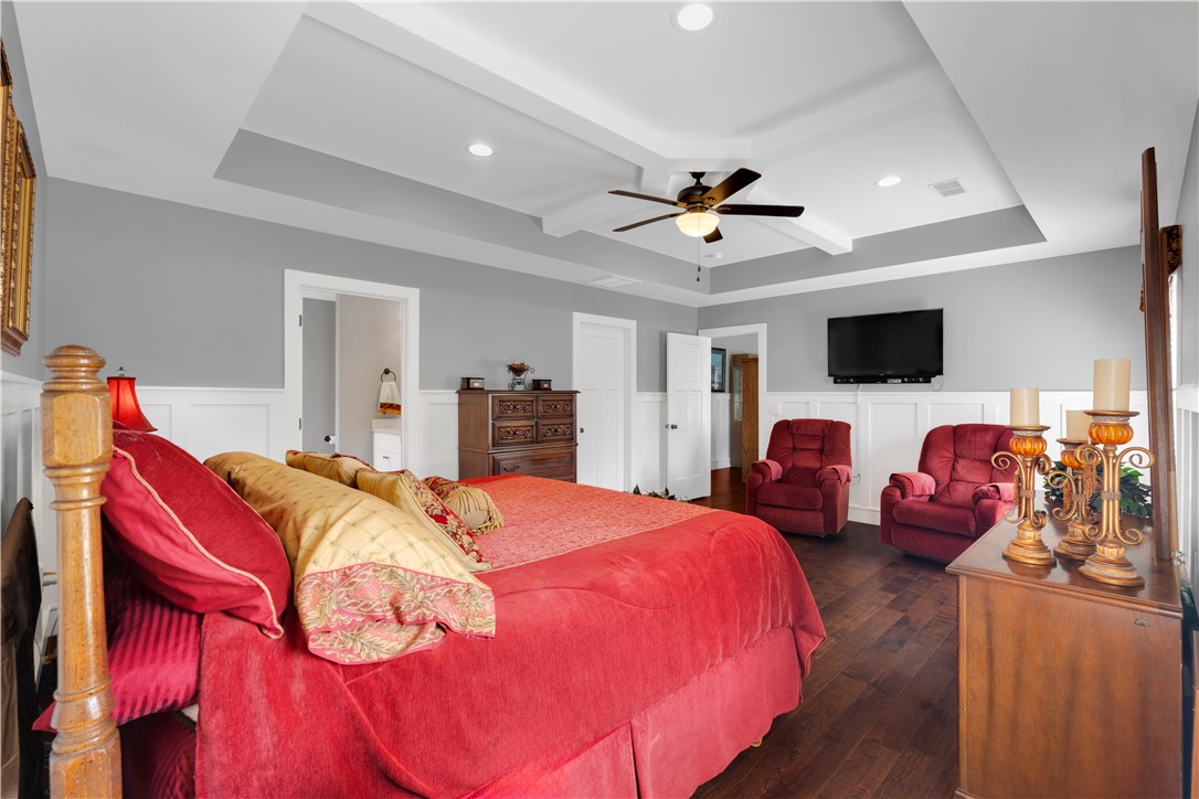 181 Amberwood Drive Anderson, SC 29621 - Photo 16 of 28 This spacious bedroom features a sophisticated tray ceiling and rich hardwood flooring.