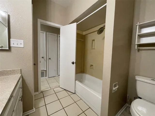a view of backyard with large trees and wooden fence