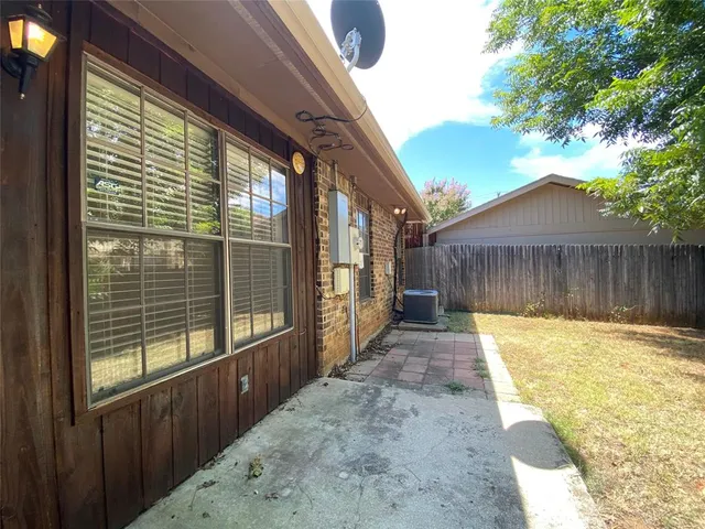 a view of backyard with a patio