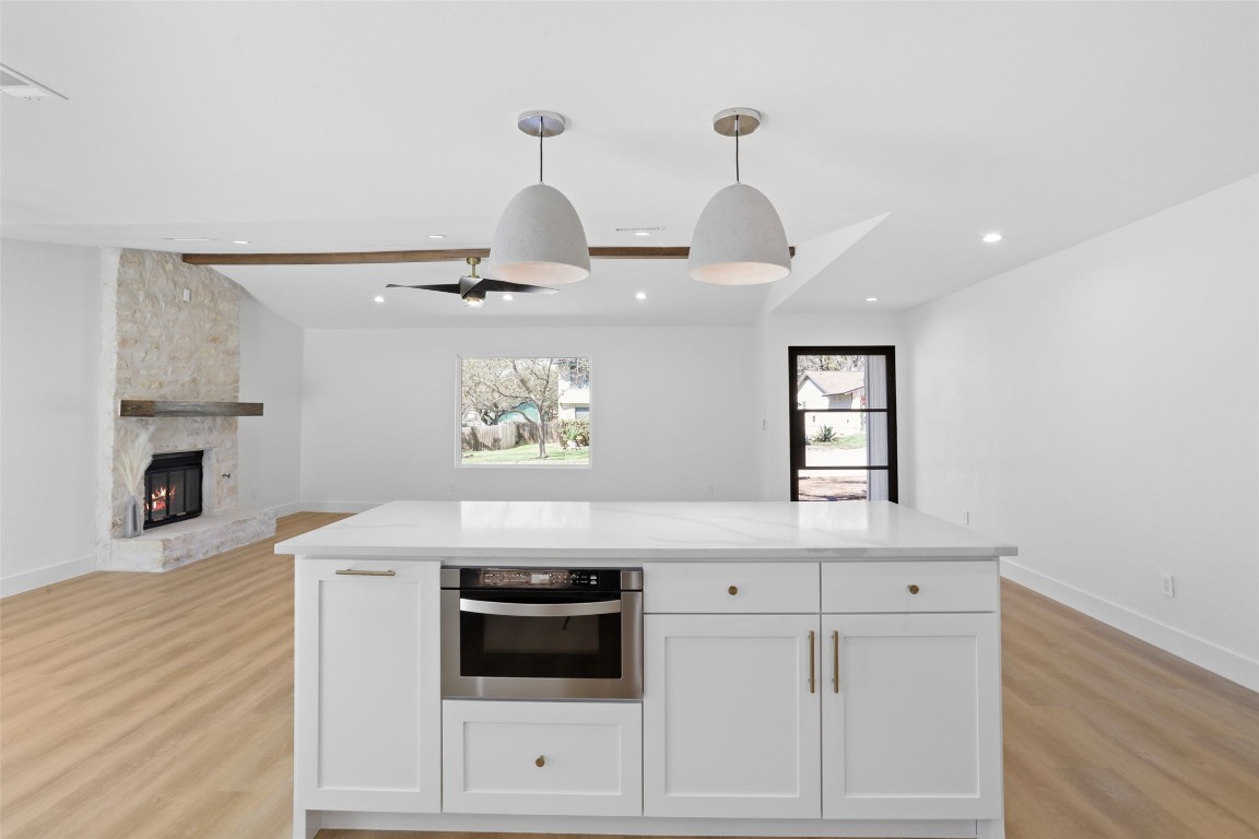 9229 Independence Loop Austin, TX 78748 - Photo 7 of 24 Kitchen island featuring microwave drawer and quartz countertop