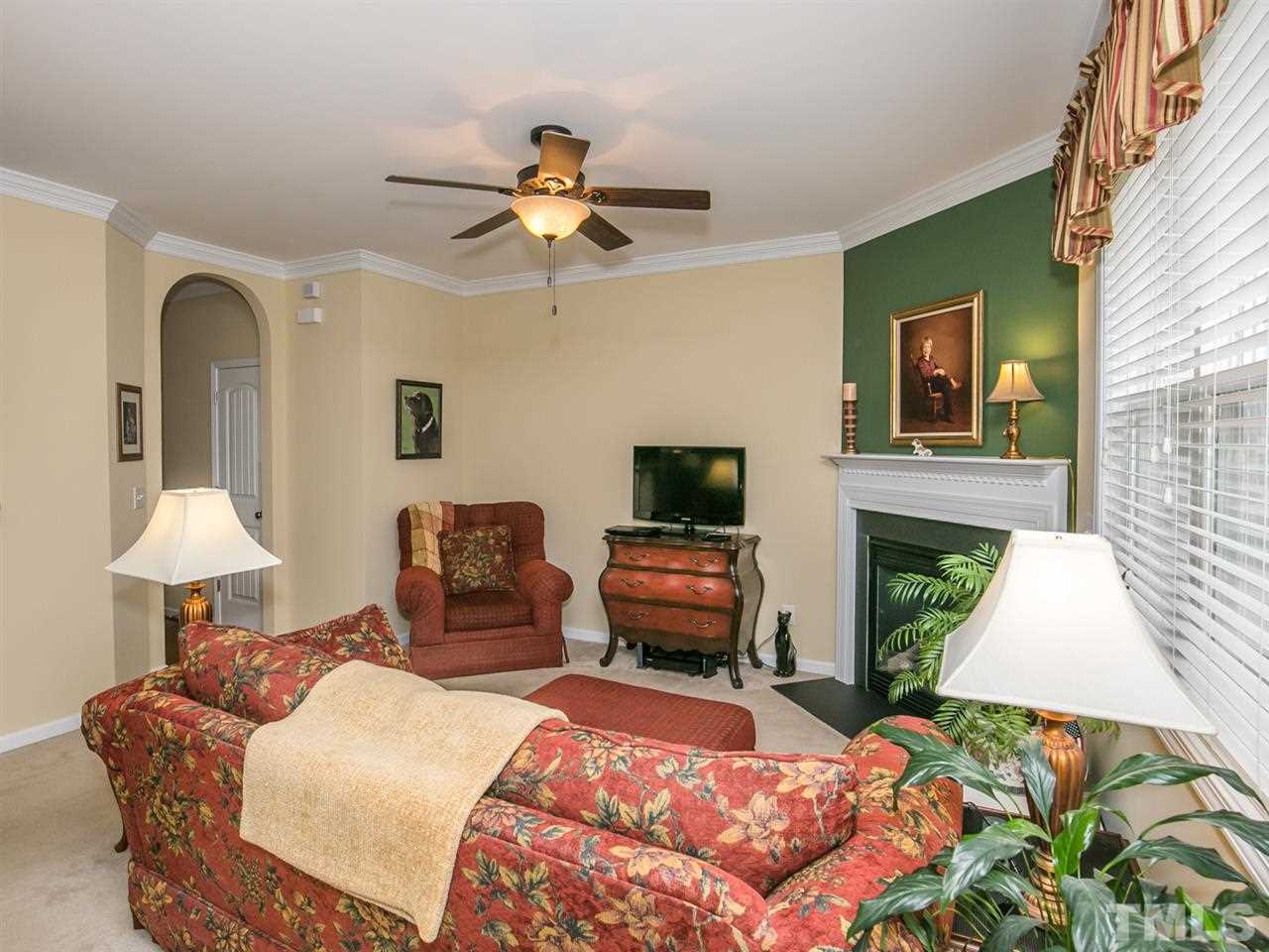4607 Altha Street Raleigh, NC 27606 - Photo 2 of 23 a bedroom with a bed and a chandelier