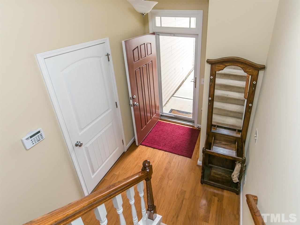 4607 Altha Street Raleigh, NC 27606 - Photo 12 of 23 a view of a hallway with wooden floor and staircase