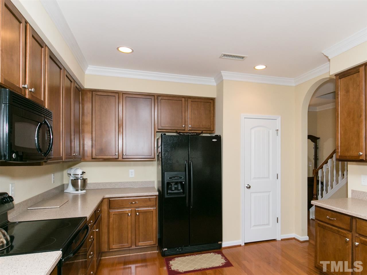 4607 Altha Street Raleigh, NC 27606 - Photo 13 of 23 a kitchen with granite countertop stainless steel appliances a refrigerator a stove top oven and sink