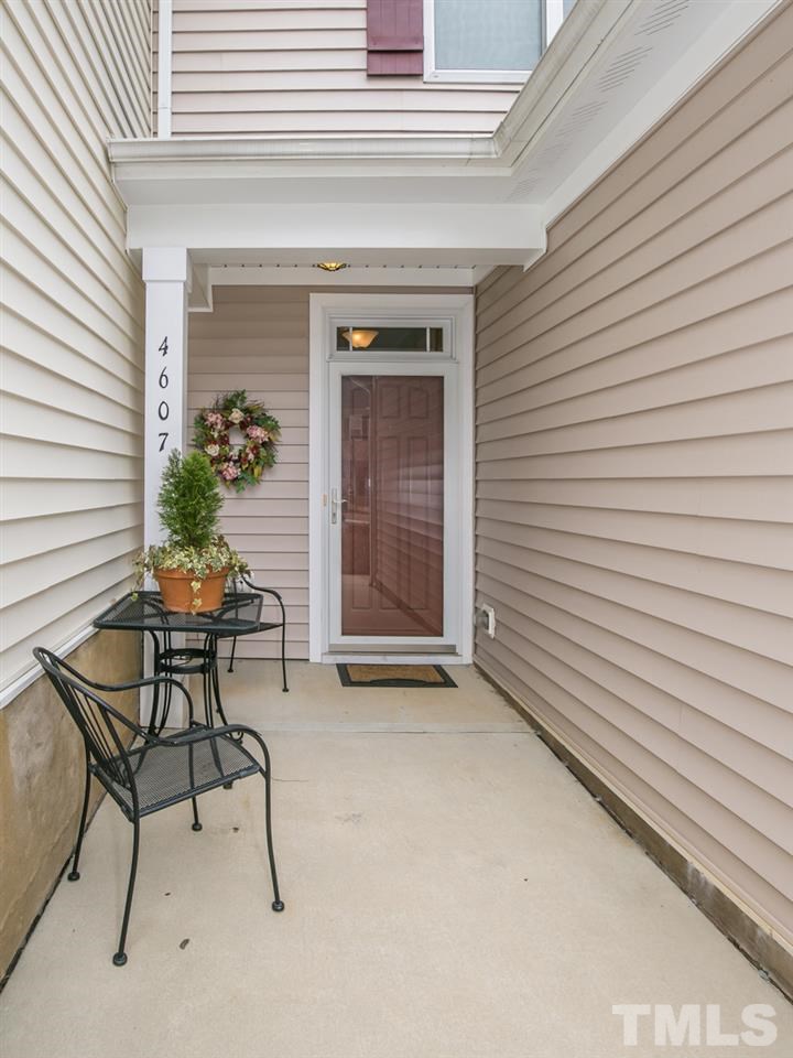4607 Altha Street Raleigh, NC 27606 - Photo 17 of 23 a patio with a table and chairs and potted plants