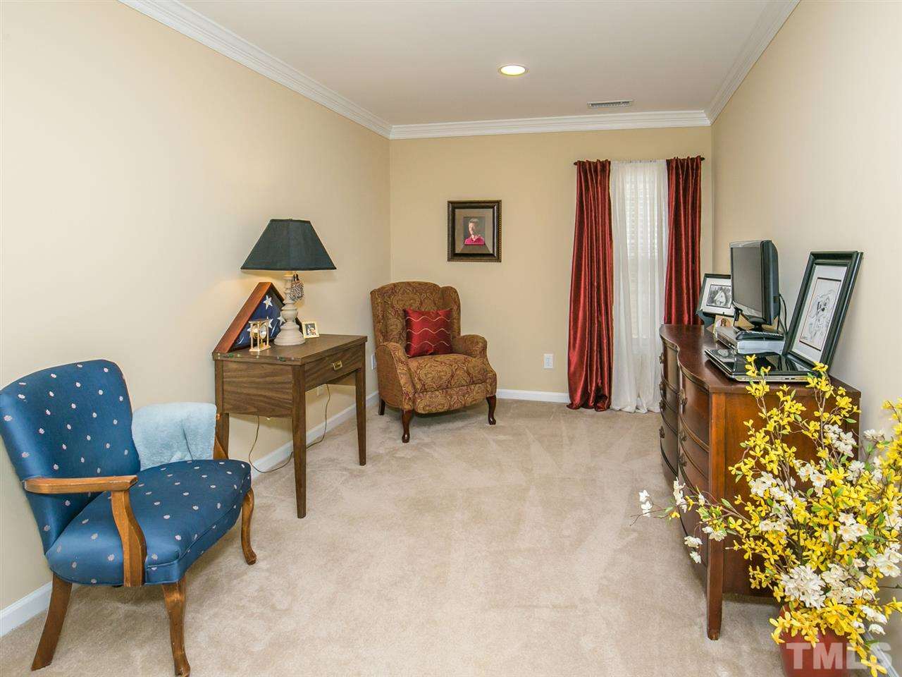 4607 Altha Street Raleigh, NC 27606 - Photo 18 of 23 a living room with furniture a couch and a flat screen tv