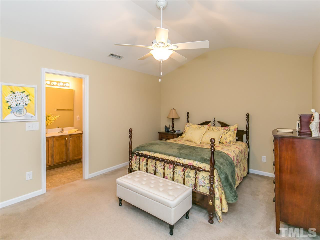 4607 Altha Street Raleigh, NC 27606 - Photo 20 of 23 a bedroom with a bed and a chandelier