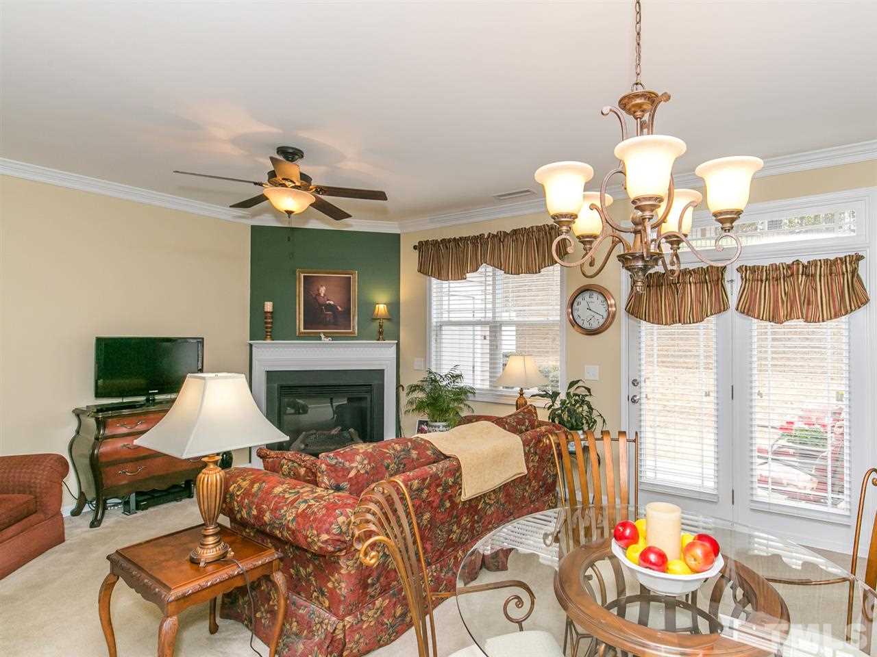4607 Altha Street Raleigh, NC 27606 - Photo 21 of 23 a living room with furniture chandelier and a fireplace
