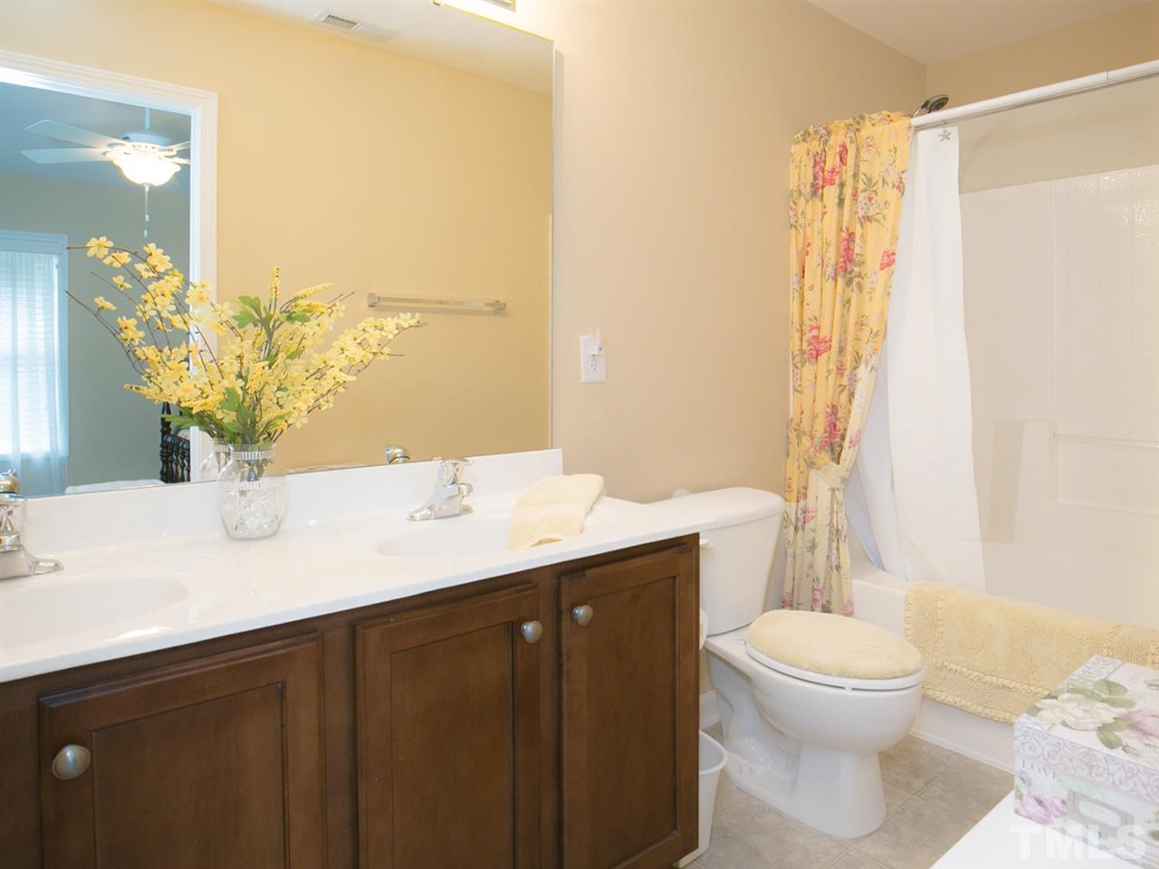 4607 Altha Street Raleigh, NC 27606 - Photo 22 of 23 a bathroom with a granite countertop sink toilet and shower