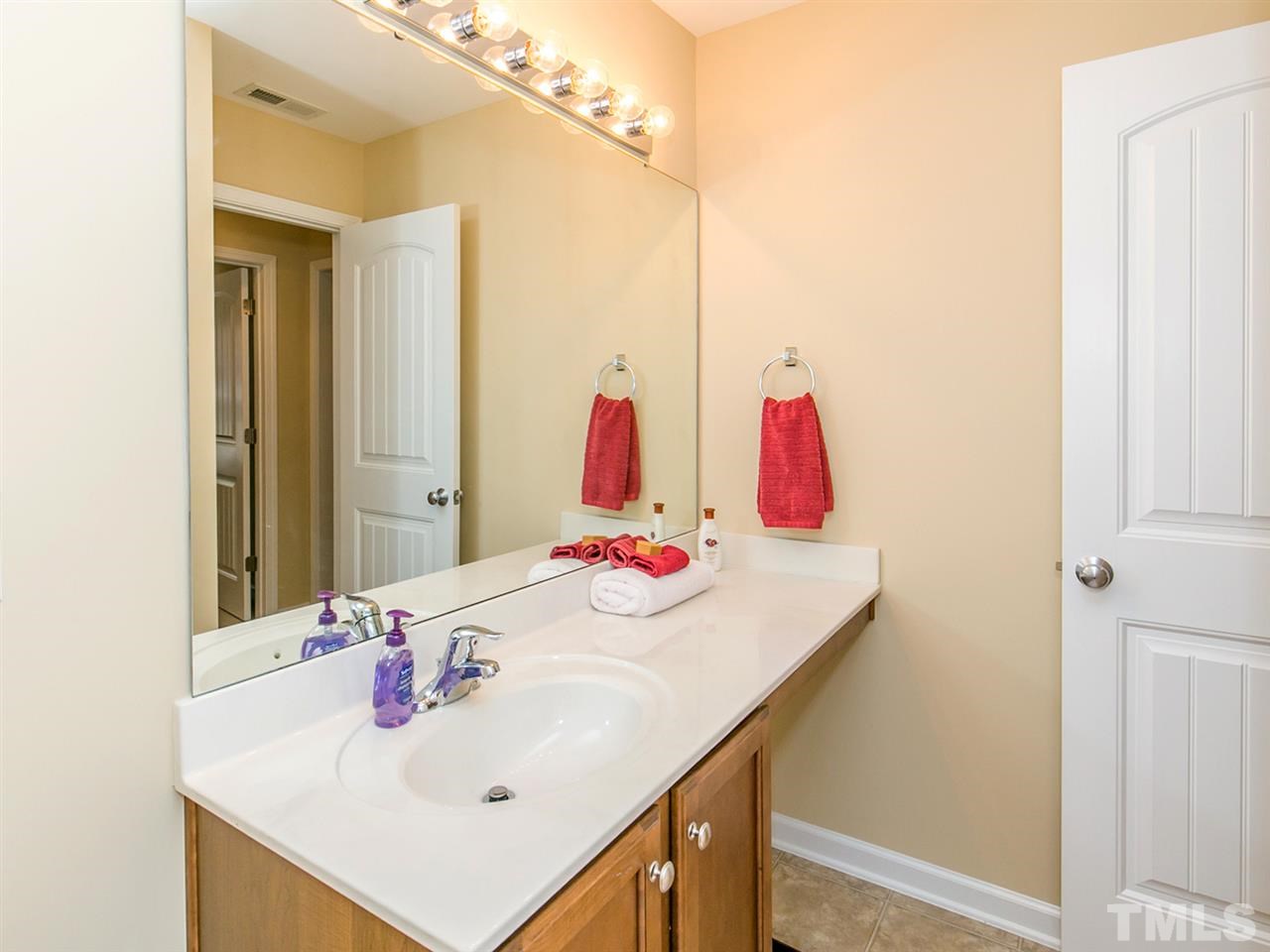 4607 Altha Street Raleigh, NC 27606 - Photo 23 of 23 a bathroom with a sink and a mirror