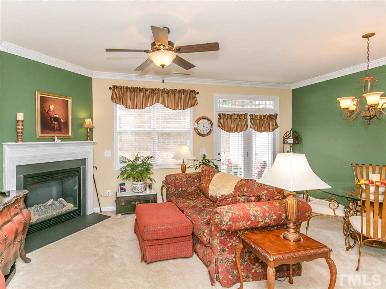 4607 Altha Street Raleigh, NC 27606 - Photo 4 of 23 a living room with furniture a chandelier and a fireplace