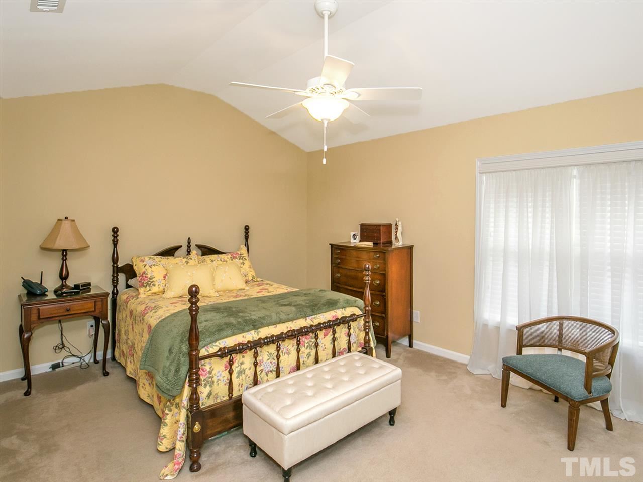 4607 Altha Street Raleigh, NC 27606 - Photo 5 of 23 a bedroom with a bed and a chair
