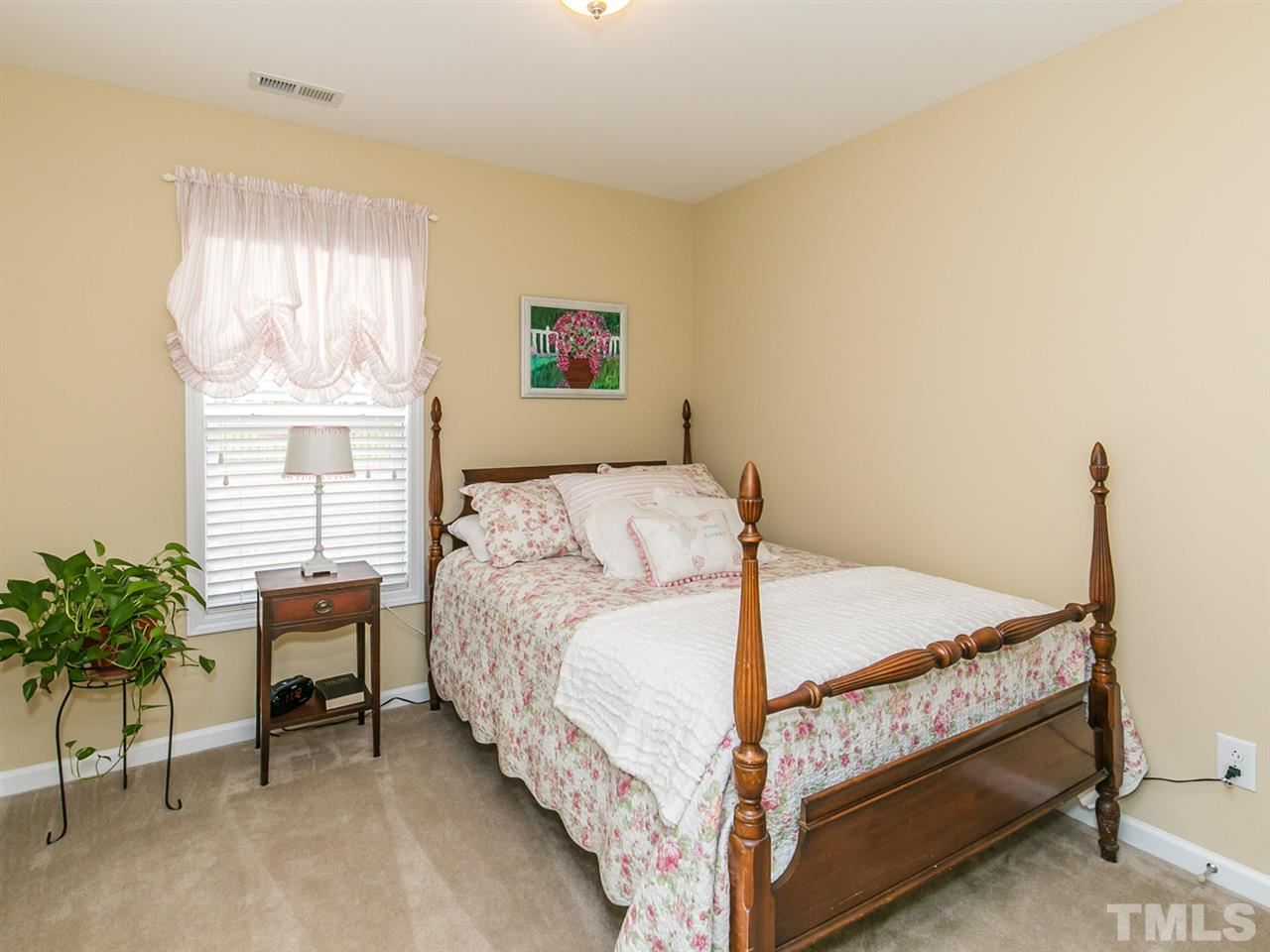 4607 Altha Street Raleigh, NC 27606 - Photo 6 of 23 a bedroom with a bed and a window