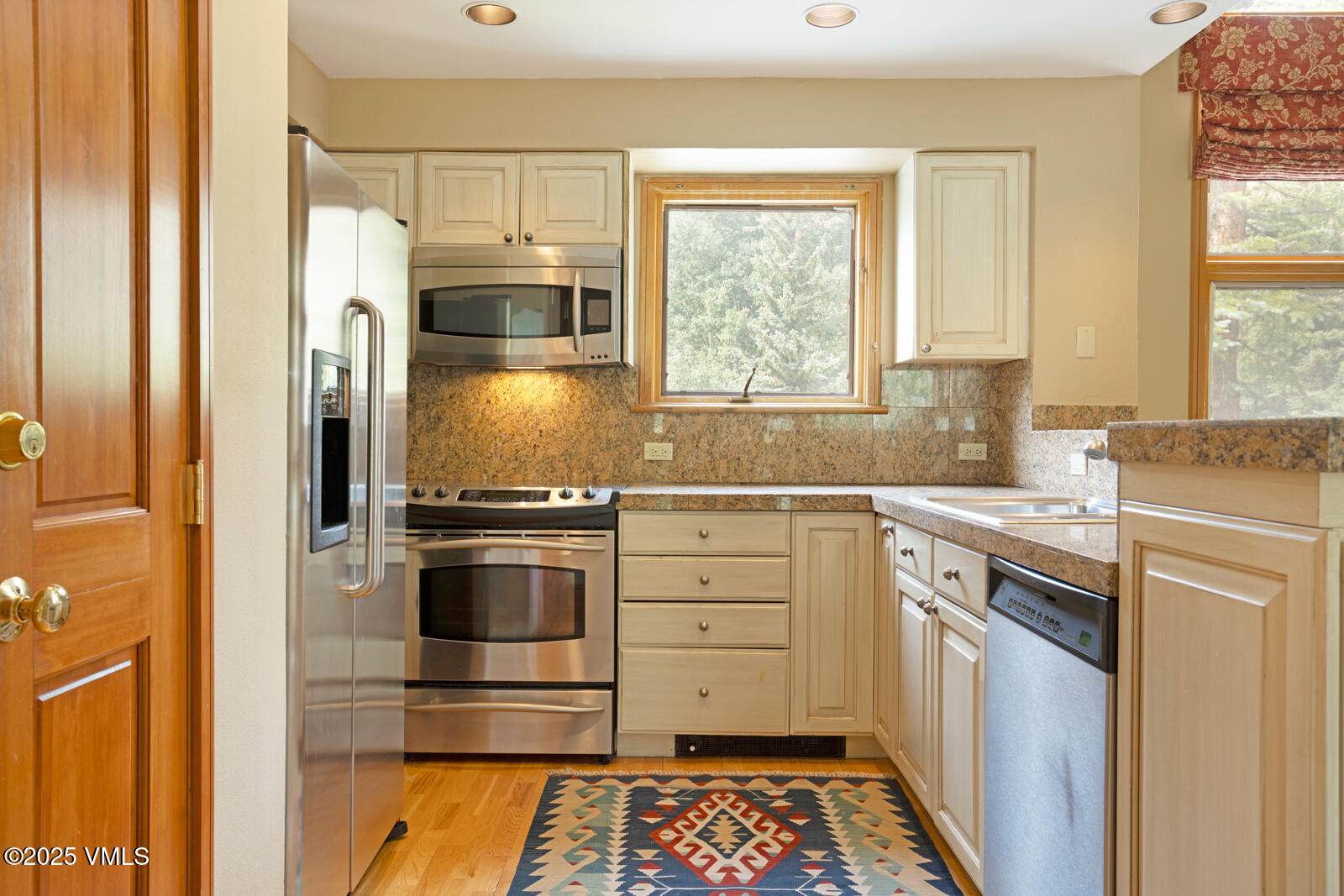 380 Offerson Road, Unit K2 Beaver Creek, CO 81620 - Photo 12 of 40 a kitchen with granite countertop a sink stainless steel appliances and cabinets
