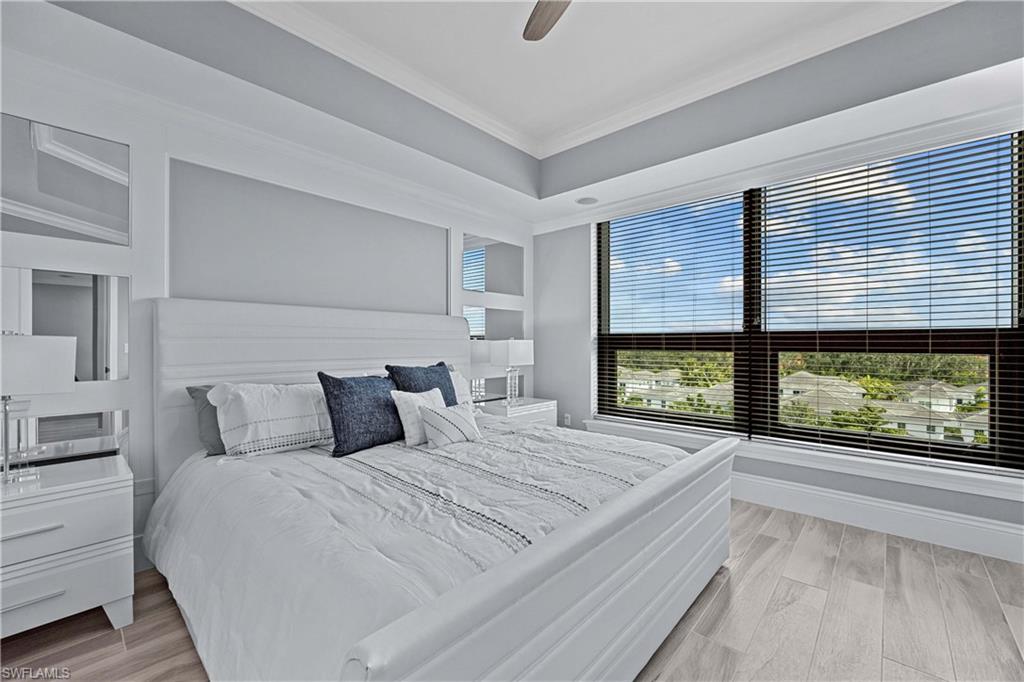 9115 Strada Place, Unit 5511 Naples, FL 34108 - Photo 12 of 38 a bedroom with a large bed and a large window