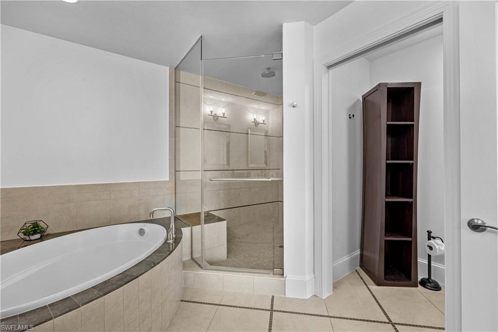 9115 Strada Place, Unit 5511 Naples, FL 34108 - Photo 15 of 38 a bathroom with a bathtub and a shower