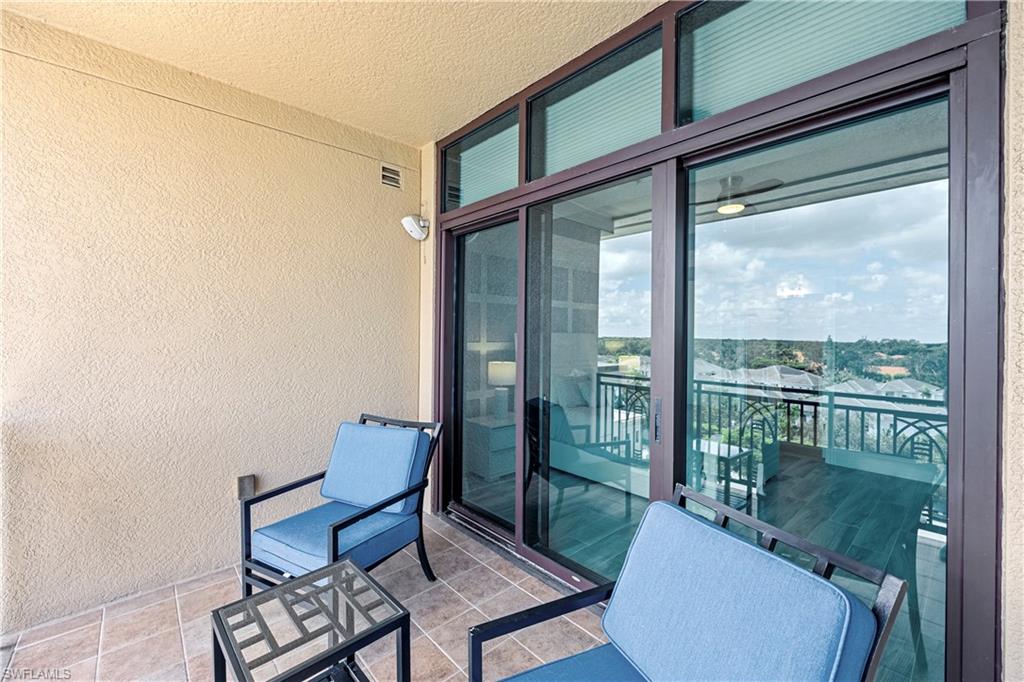 9115 Strada Place, Unit 5511 Naples, FL 34108 - Photo 22 of 38 a living room with furniture and a window