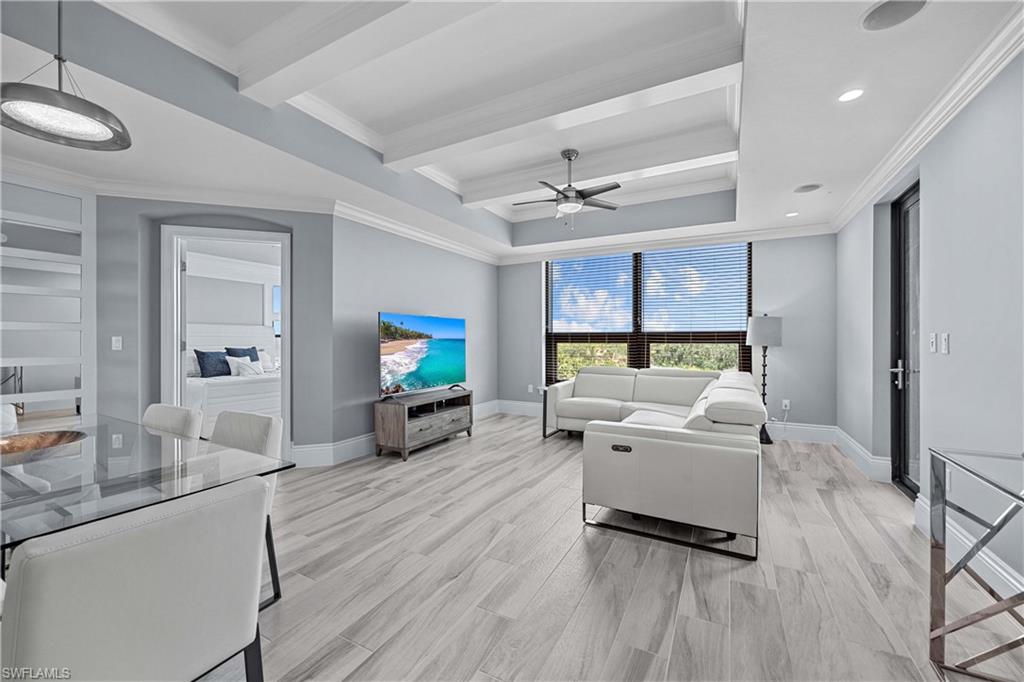 9115 Strada Place, Unit 5511 Naples, FL 34108 - Photo 3 of 38 a living room with furniture and a flat screen tv