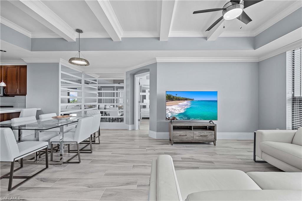 9115 Strada Place, Unit 5511 Naples, FL 34108 - Photo 4 of 38 a living room with furniture and a flat screen tv