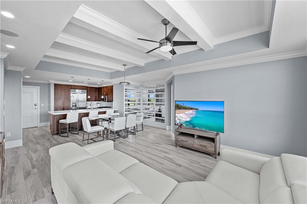 9115 Strada Place, Unit 5511 Naples, FL 34108 - Photo 5 of 38 a living room with furniture and a flat screen tv