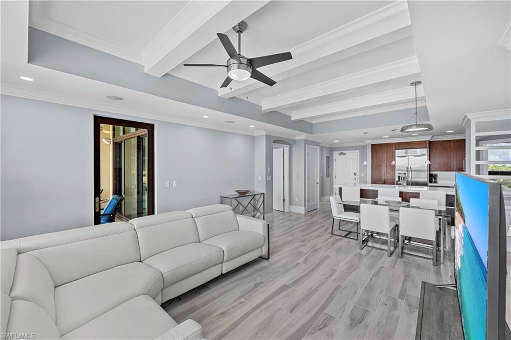 9115 Strada Place, Unit 5511 Naples, FL 34108 - Photo 6 of 38 a living room with furniture and a wooden floor