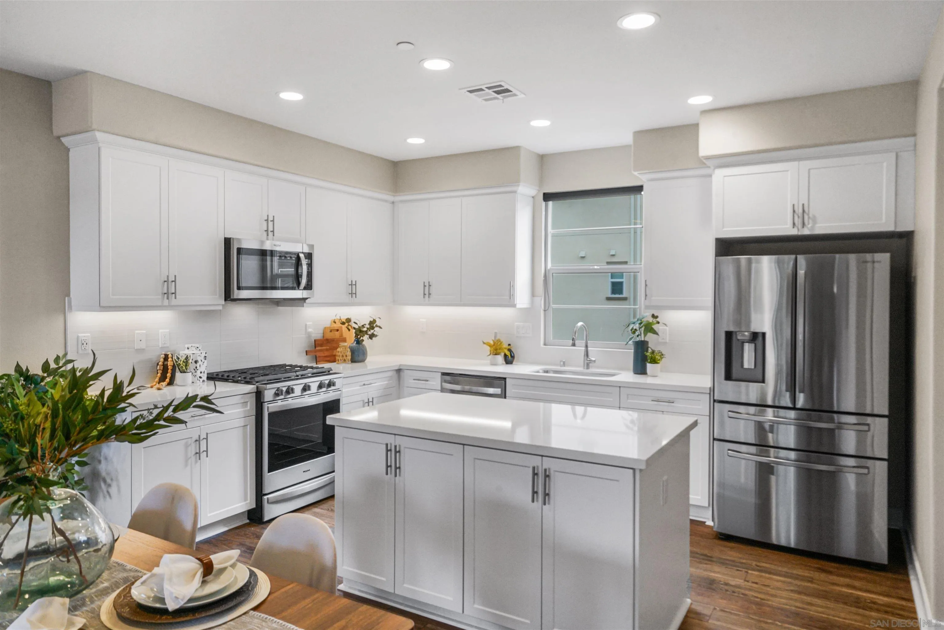 4348 Nautilus Way, Unit 4 Oceanside, CA 92056 - Photo 7 of 34 a kitchen with stainless steel appliances a stove a sink a refrigerator and a refrigerator