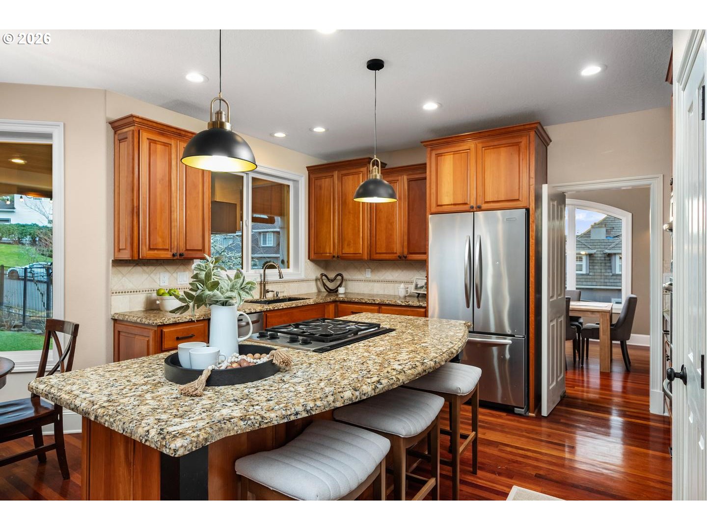 12352 Northwest Hibbard Drive Portland, OR 97229 - Photo 15 of 48 a kitchen with granite countertop a table chairs and wooden floor