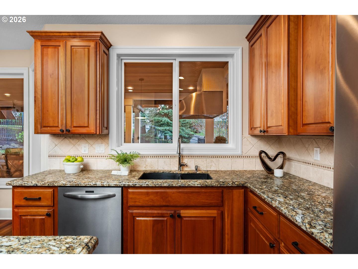 12352 Northwest Hibbard Drive Portland, OR 97229 - Photo 17 of 48 a kitchen with stainless steel appliances granite countertop a sink stove and cabinets