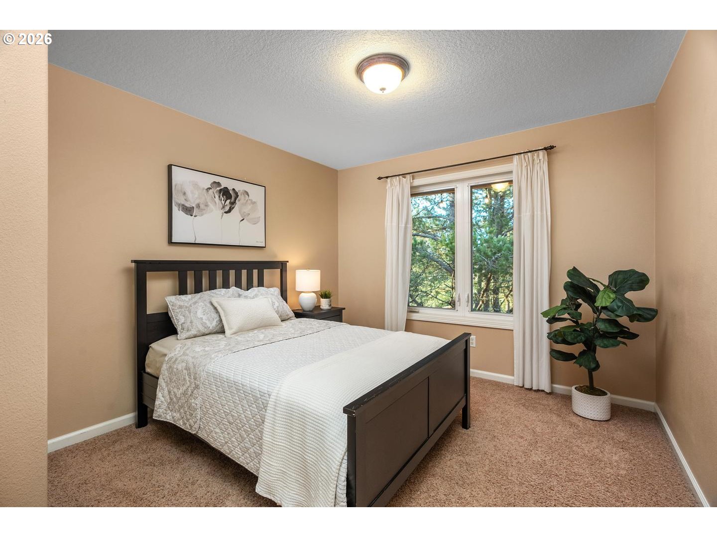 12352 Northwest Hibbard Drive Portland, OR 97229 - Photo 33 of 48 a bedroom with a bed and a potted plant