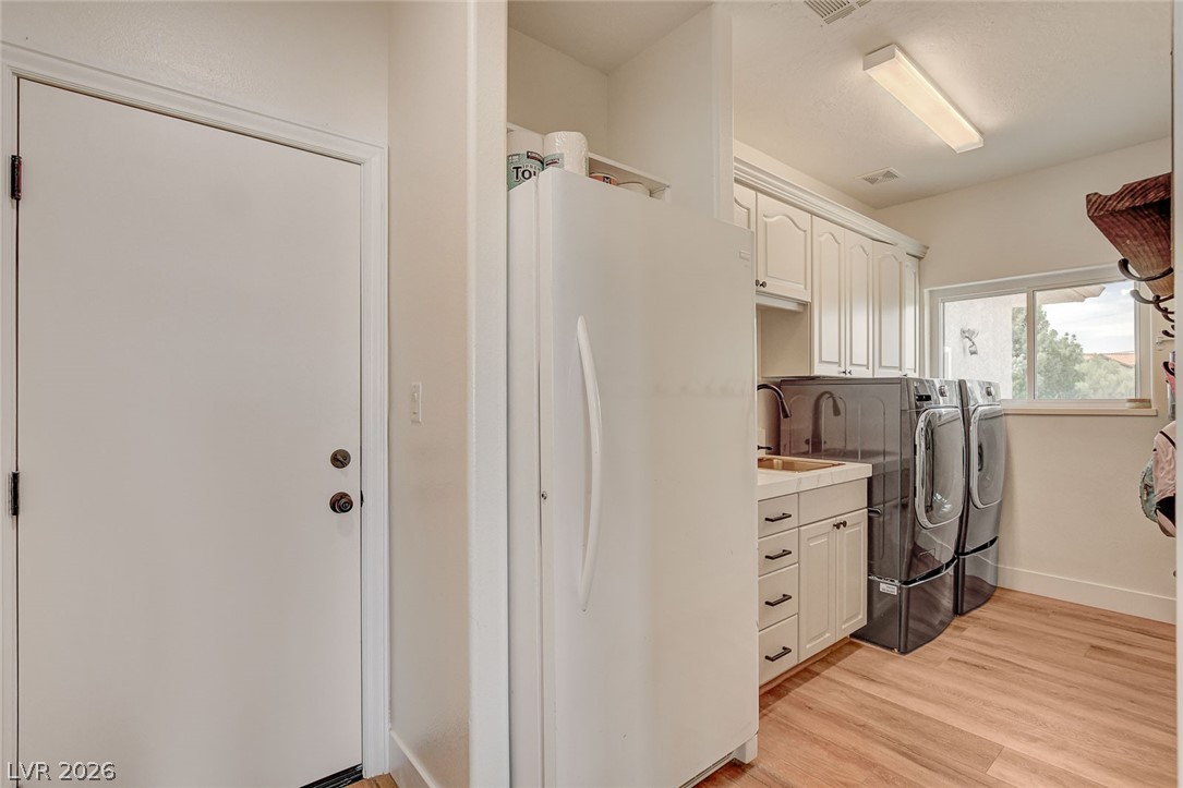 4362 Thistle Street Logandale, NV 89021 - Photo 63 of 99 Functional laundry room includes space for a washer, dryer, freezer and sink with abundant storage.