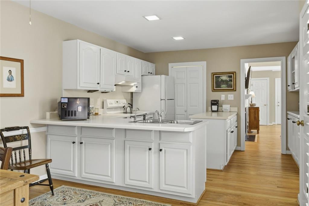 3269 Embry Downs Court Atlanta, GA 30340 - Photo 15 of 38 a kitchen with white cabinets and sink