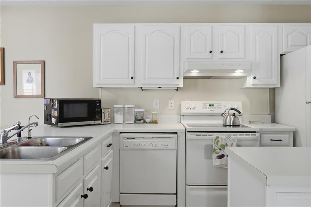 3269 Embry Downs Court Atlanta, GA 30340 - Photo 16 of 38 a kitchen with cabinets appliances a sink and a counter top