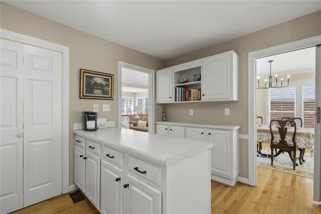 3269 Embry Downs Court Atlanta, GA 30340 - Photo 18 of 38 a kitchen with cabinets and wooden floor